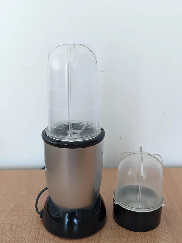 Compact blender body with a transparent cup and a second cup assembly beside it