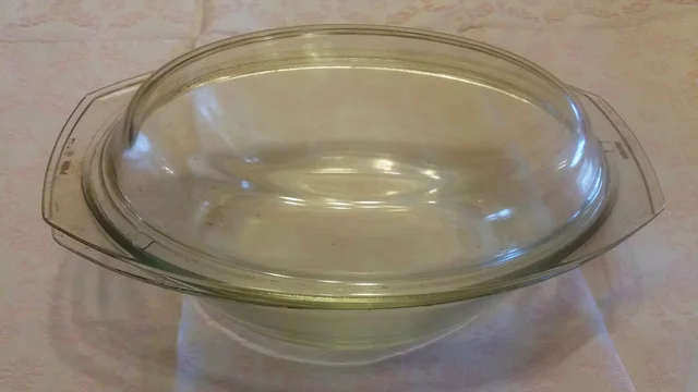 Oval glass baking dish with a separate glass cover and side handles