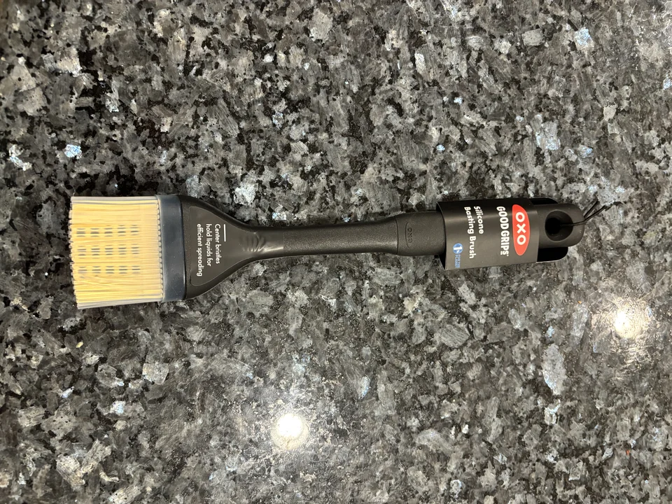 OXO Good Grips Silicone Basting Brush in labelled packaging, with black handle and yellow bristles