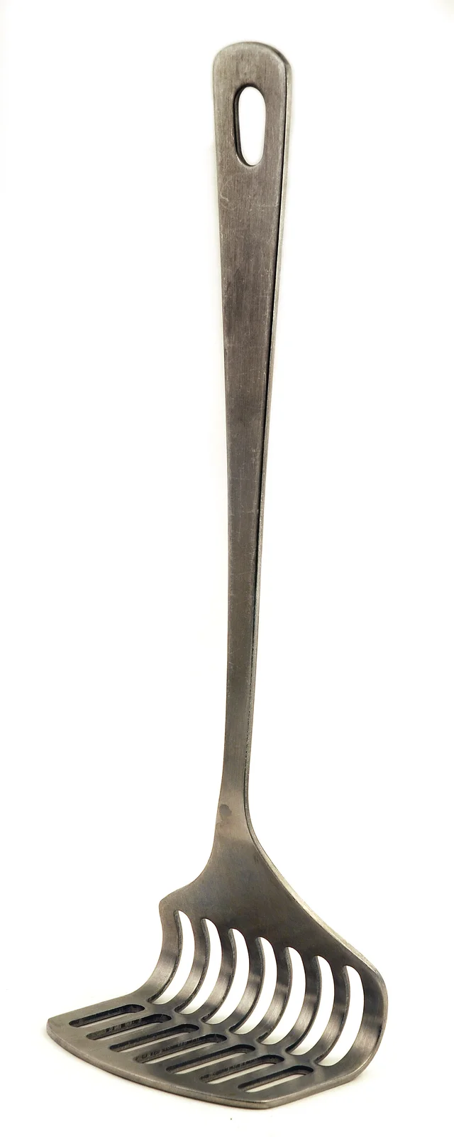 Metal potato masher with a long handle, hanging hole and a bent slotted head