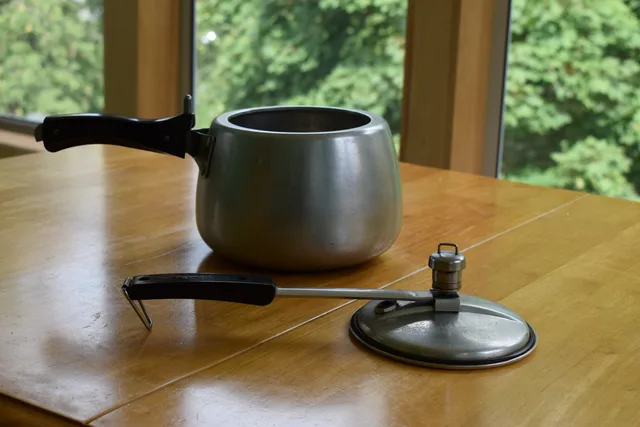 Pressure-cooker body and its separate lid on a table