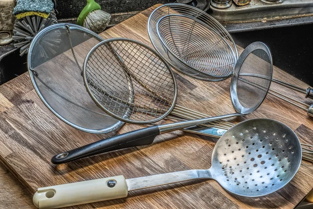 Five metal kitchen skimmers with wire, fine-mesh and perforated heads