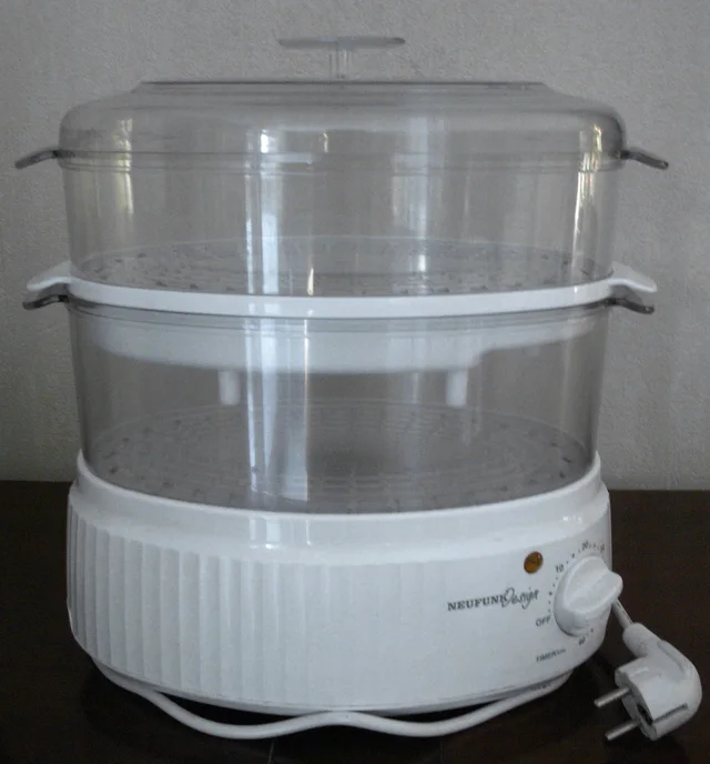 White electric food steamer with two clear tiers, lid, front control and disconnected plug